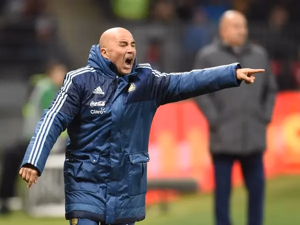 What is the difference between a football manager and a head coach?